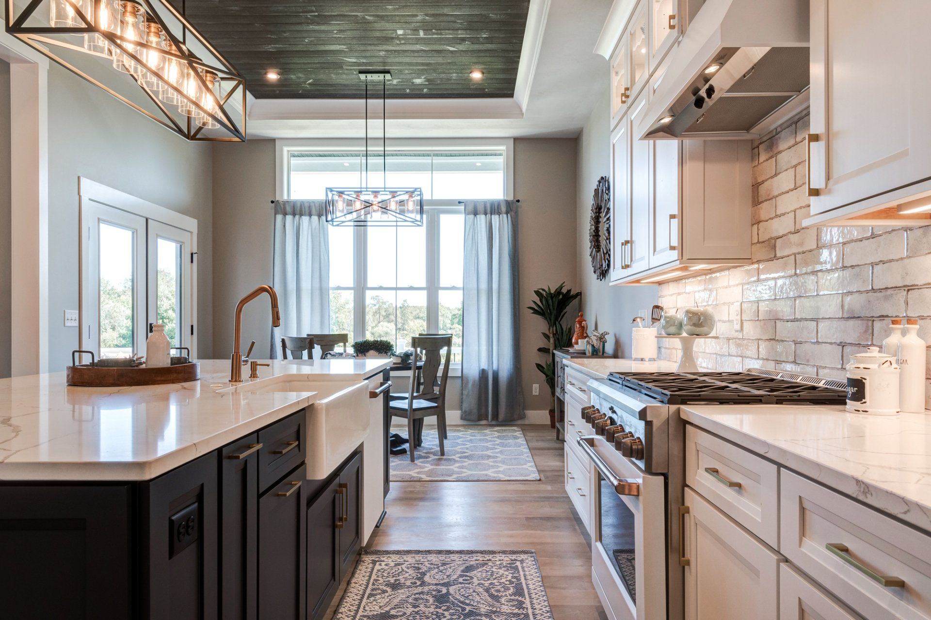 kitchen with recessed ceiling and dinette in background
