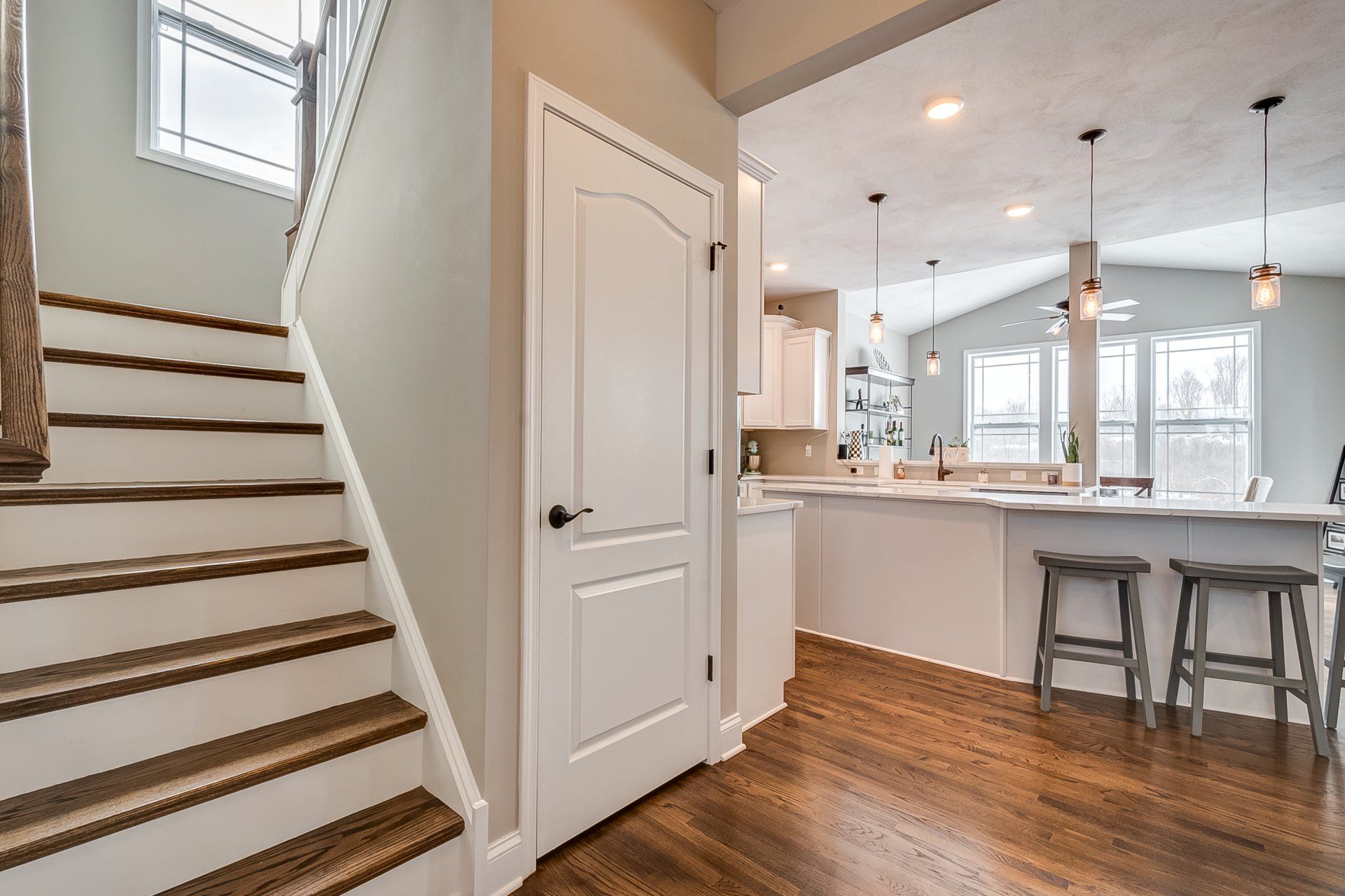 stairs and kitchen island in background