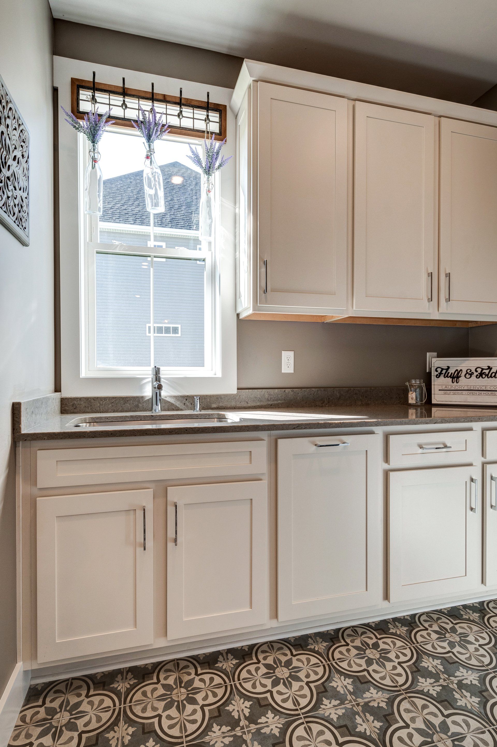 cabinets and window in front of sink