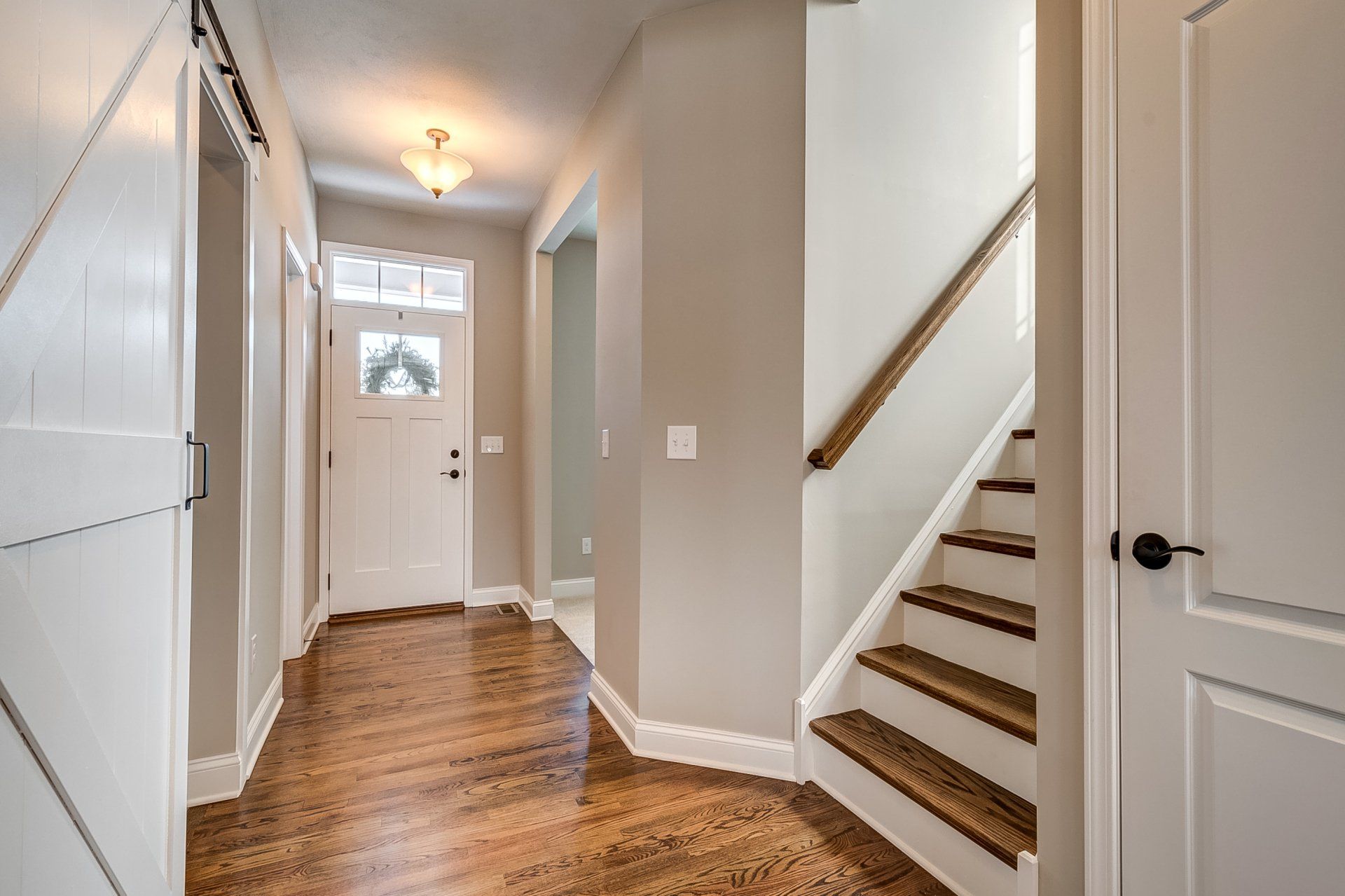 stairs, barn door, and front entryway