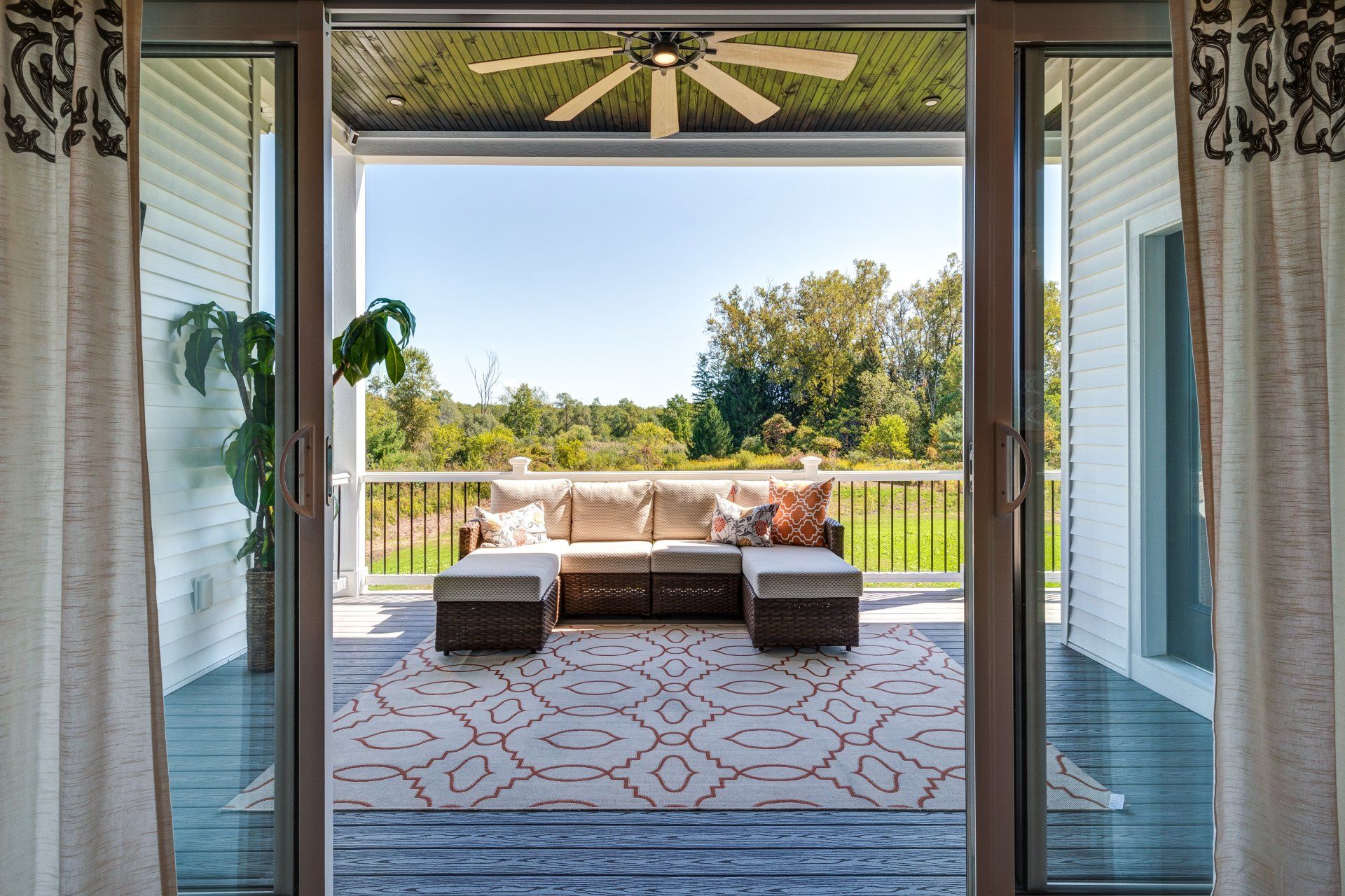 sectional on covered patio with ceiling fan