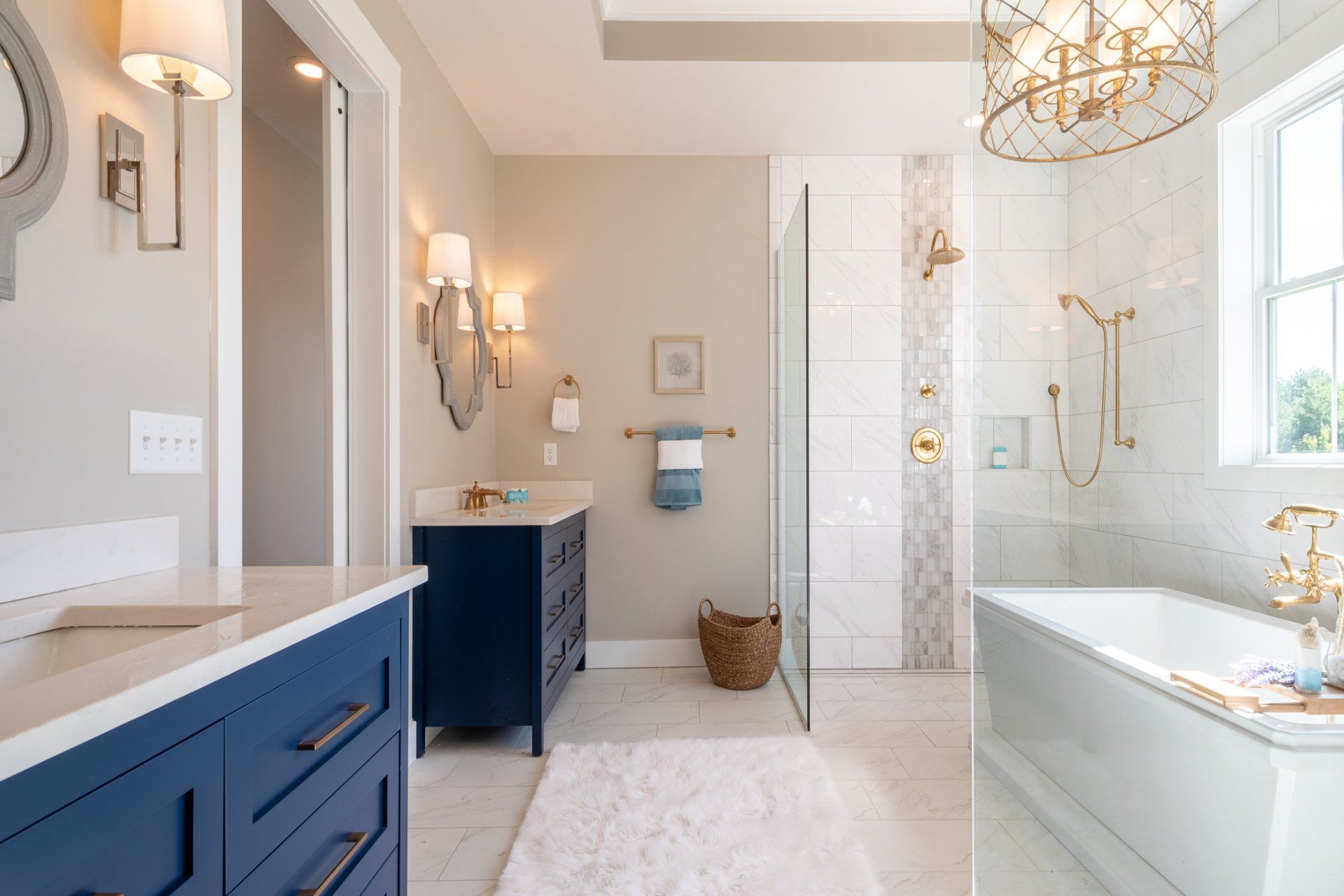 primary bathroom with separate vanities, tub, and shower