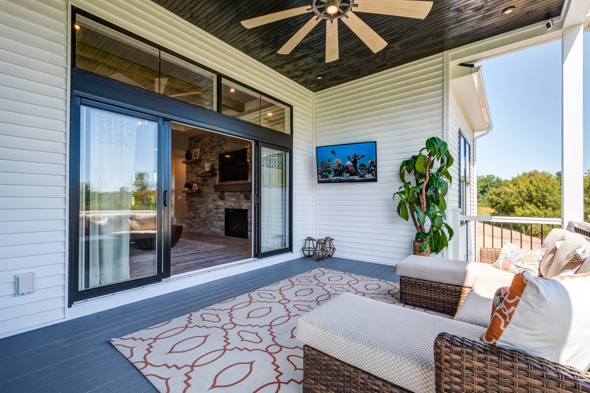 covered patio with seating and ceiling fan
