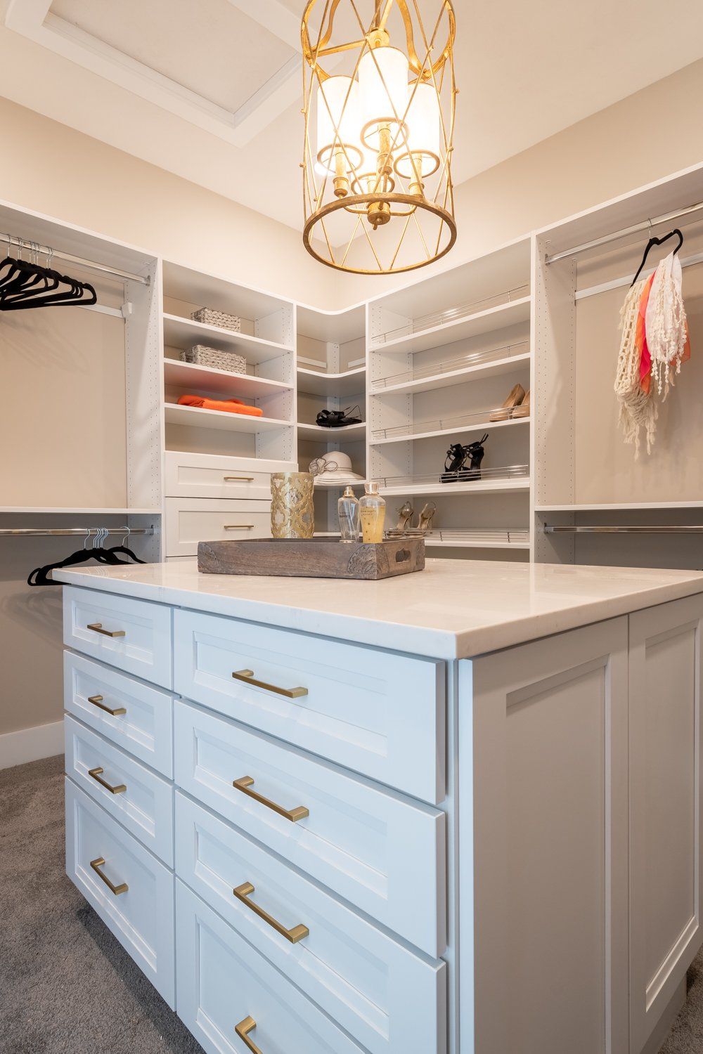 walk-in closet with island and built-in shelving