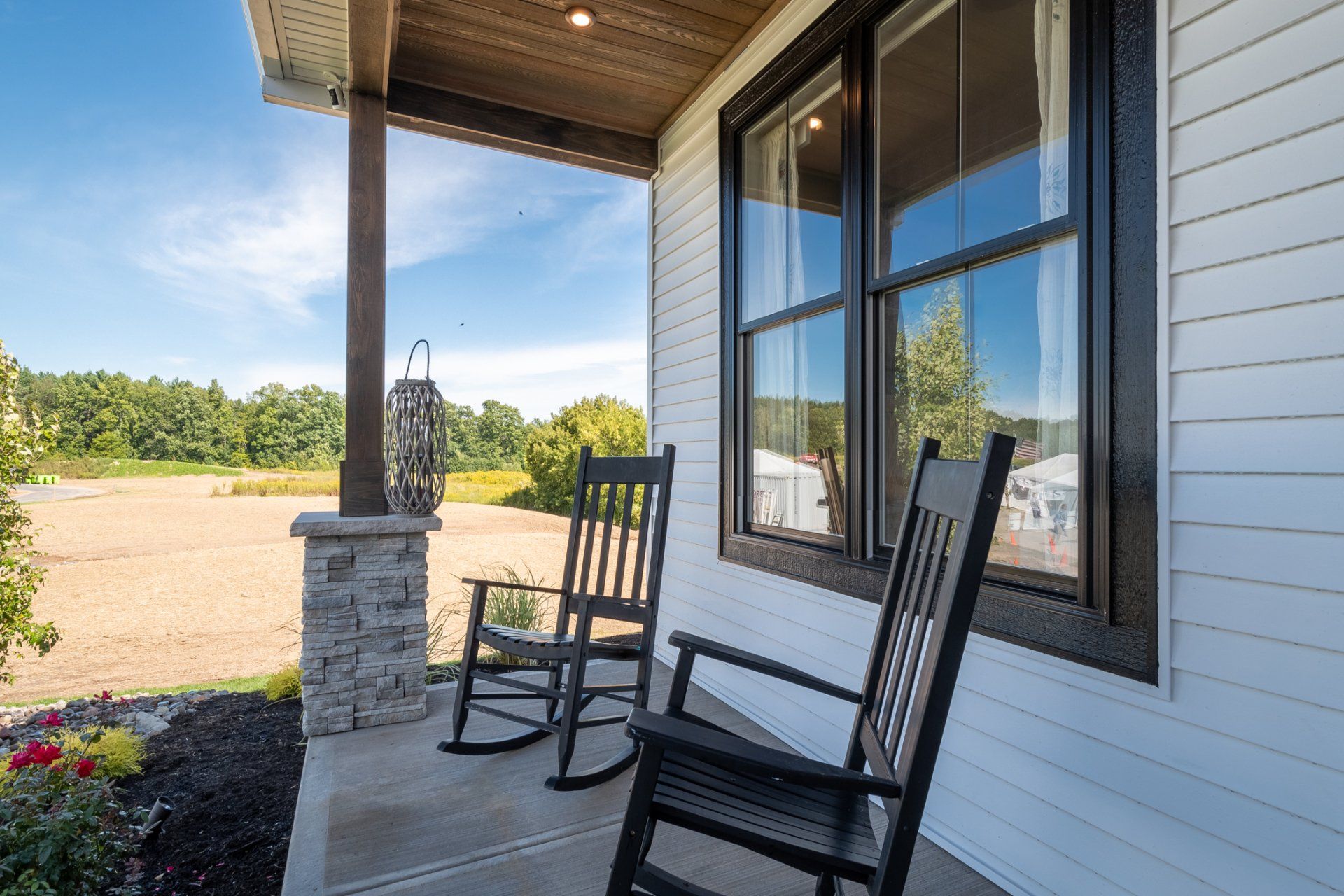 covered front porch with rocking chairs
