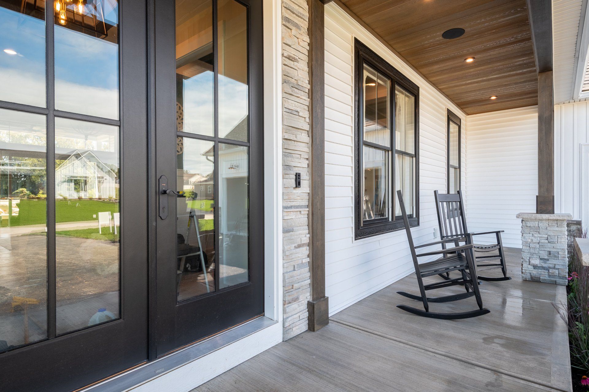 covered front porch with rocking chairs