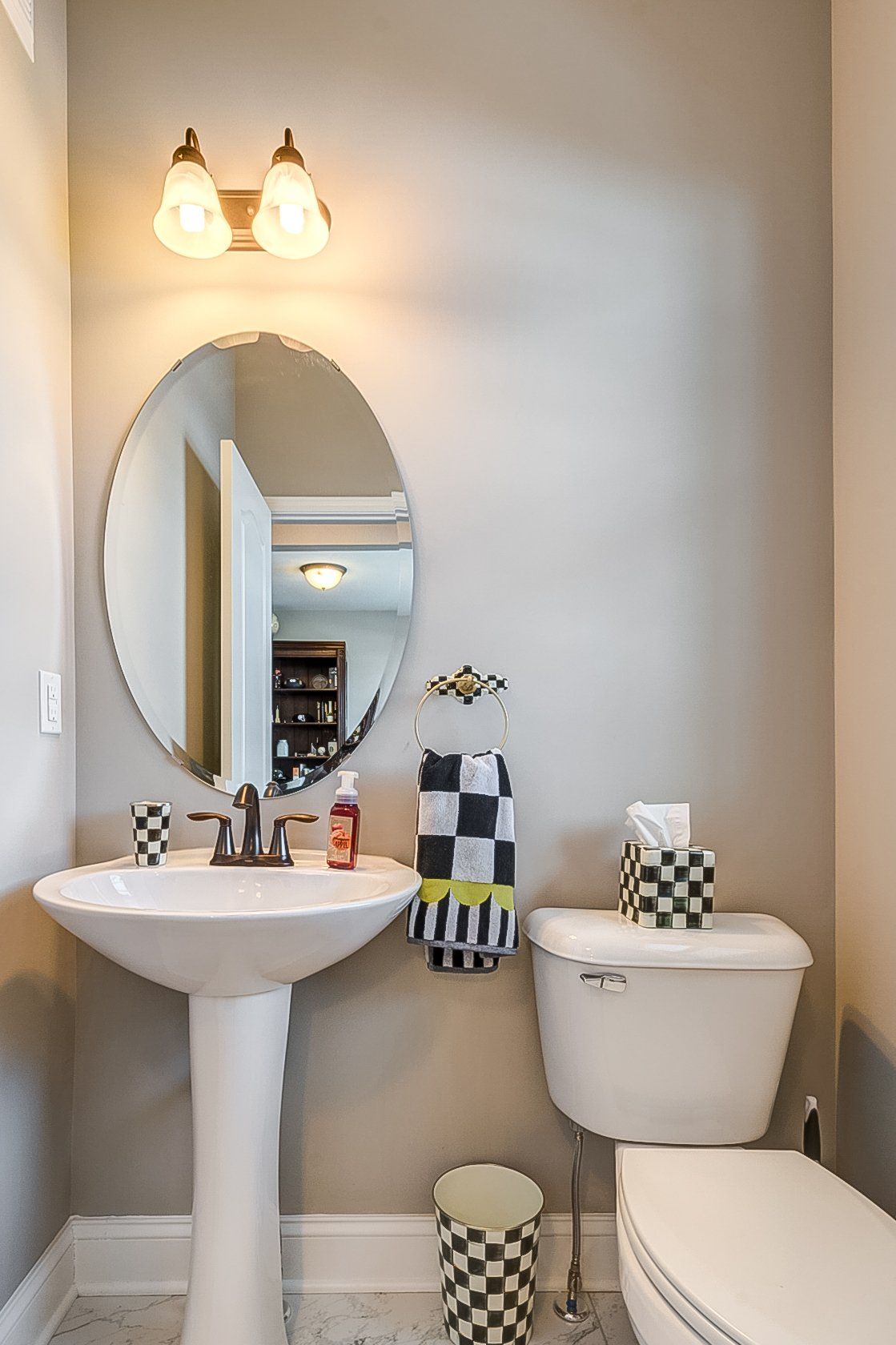pedestal sink next to toilet