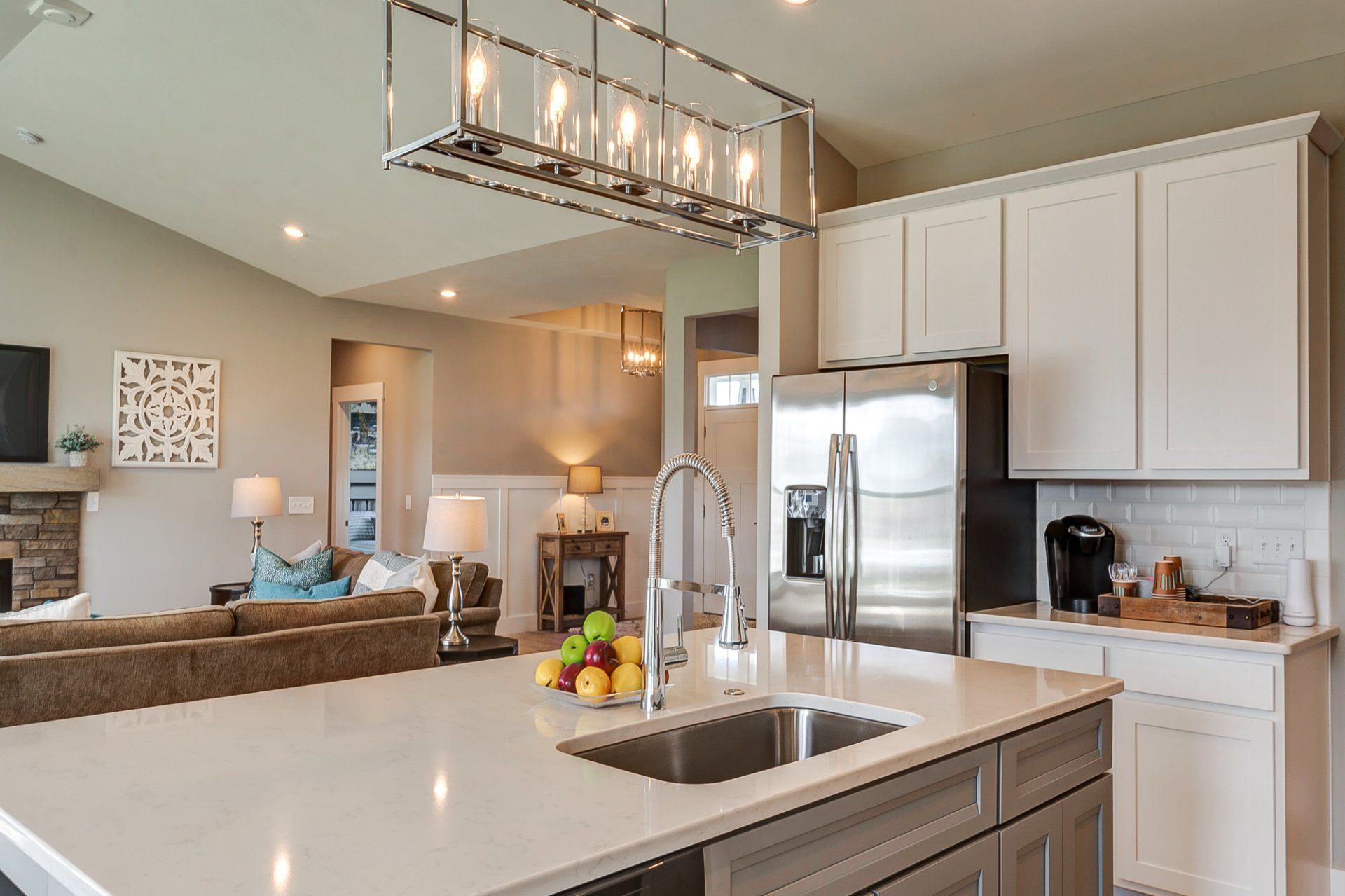 kitchen with living room and front entryway in background