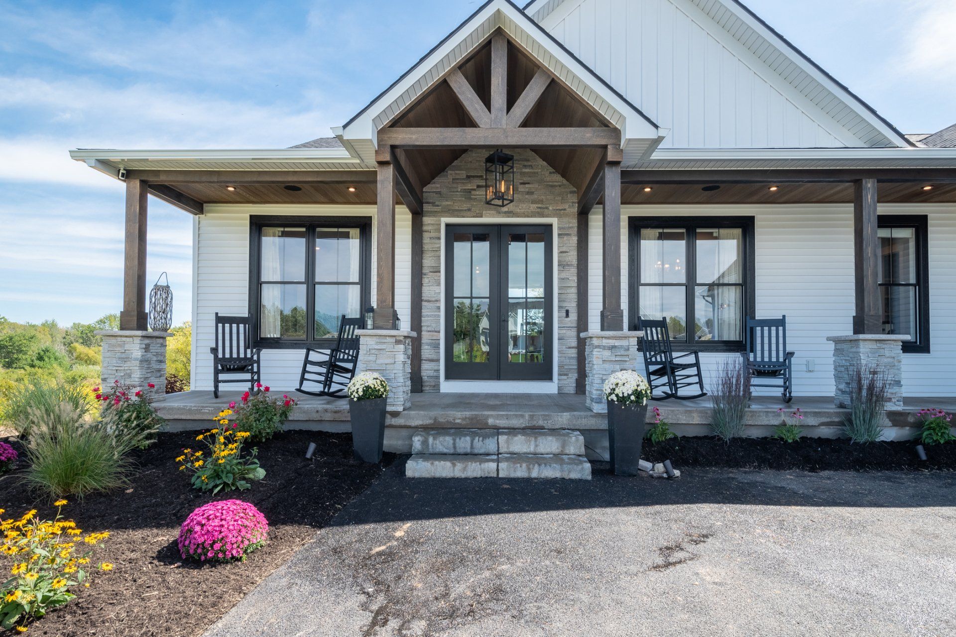 covered front porch with rocking chairs