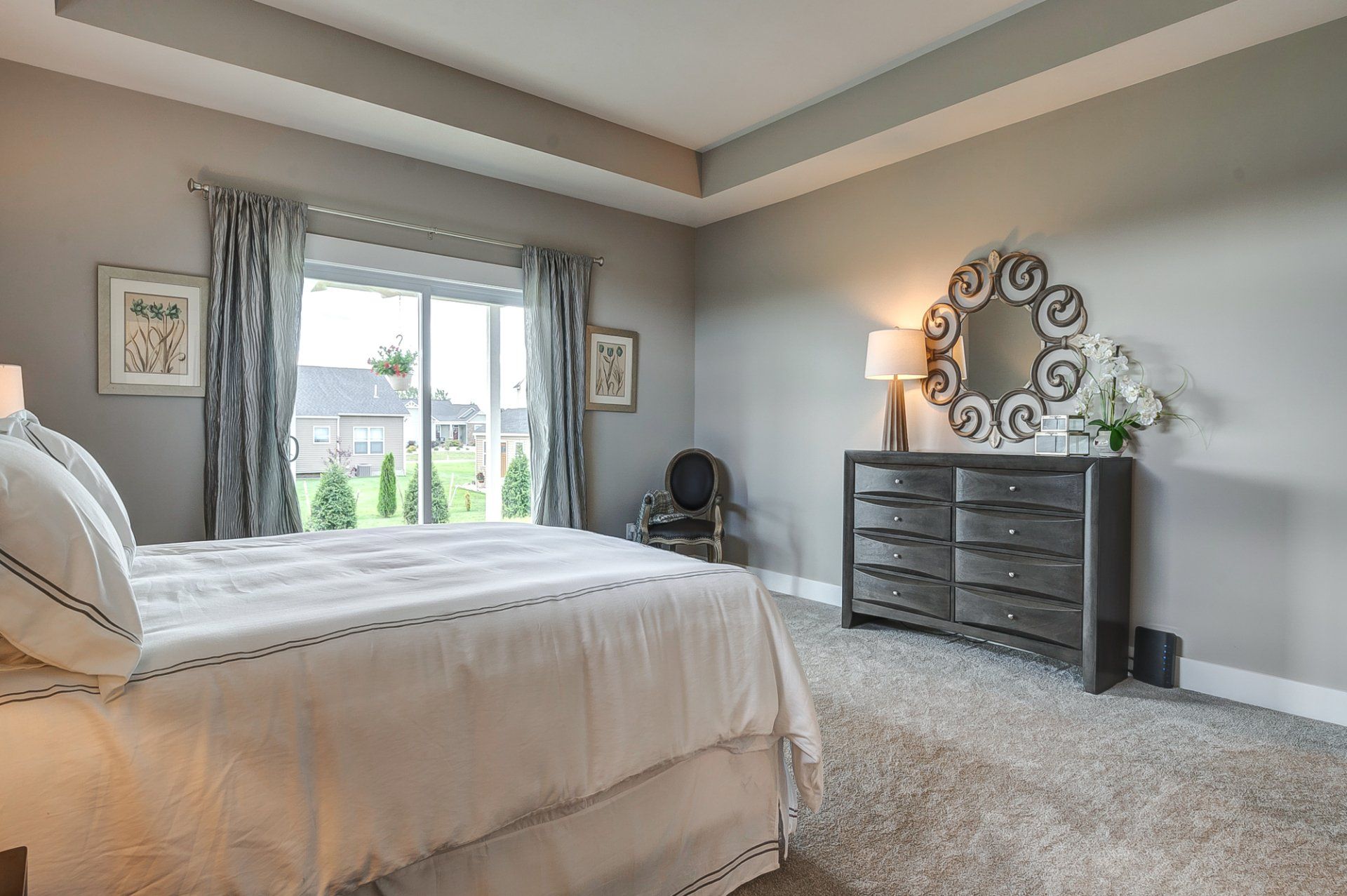 primary bedroom with recessed ceiling