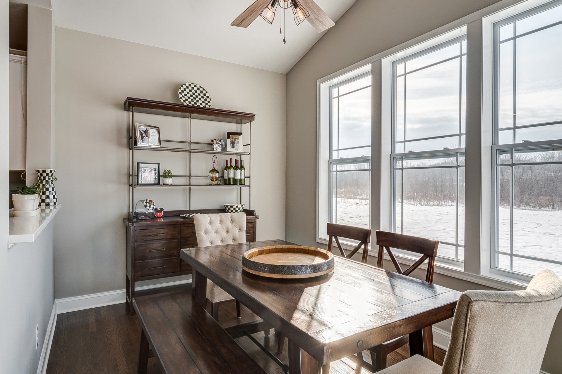 dining room with vaulted ceilings and window lighting