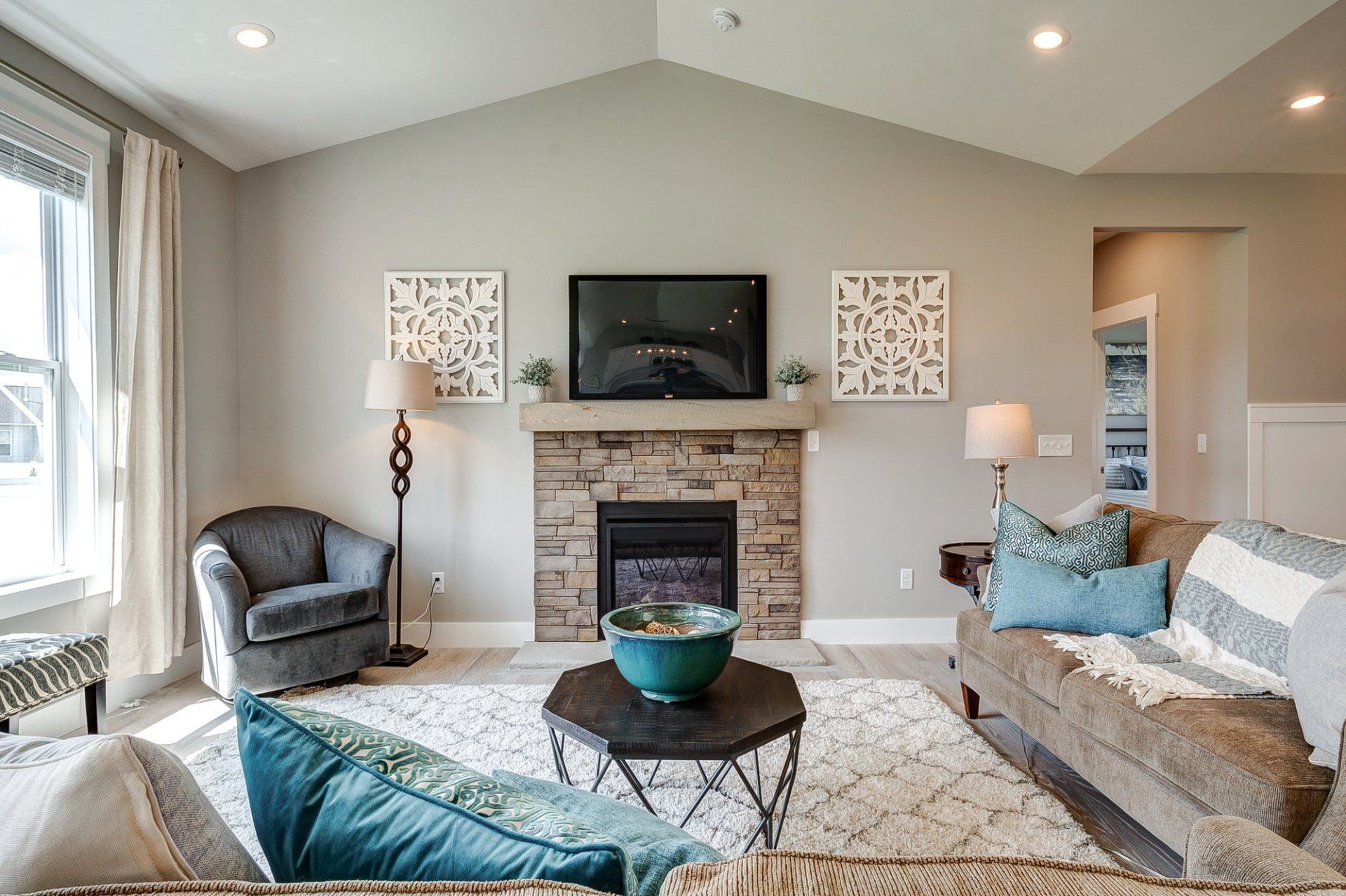 living room with vaulted ceiling and fireplace
