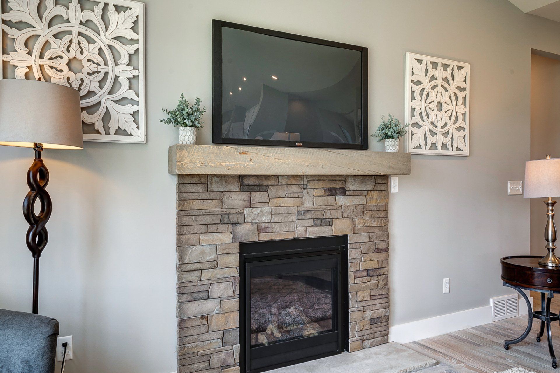 TV under stone fireplace