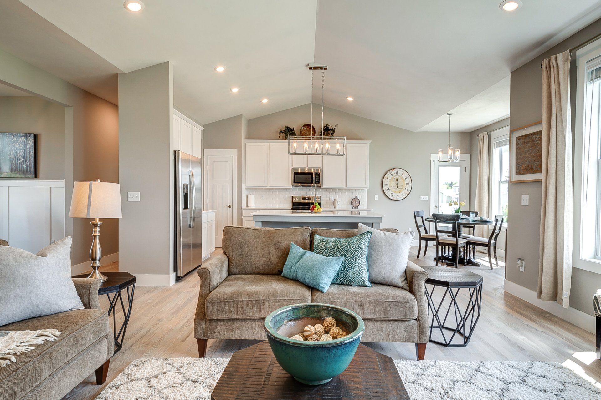 coffee table and loveseat with kitchen and dinette in background