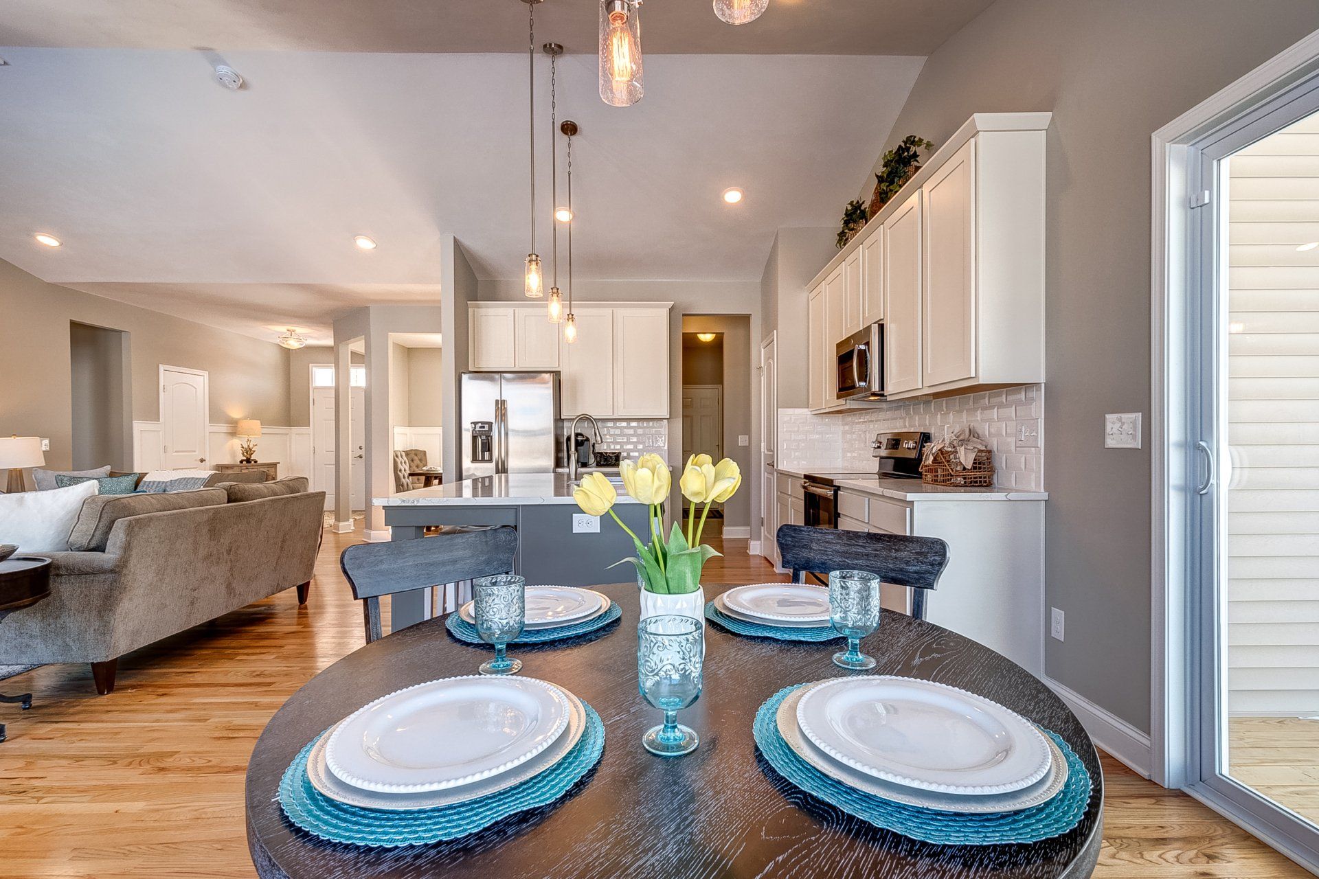dinette with door to deck and kitchen in background