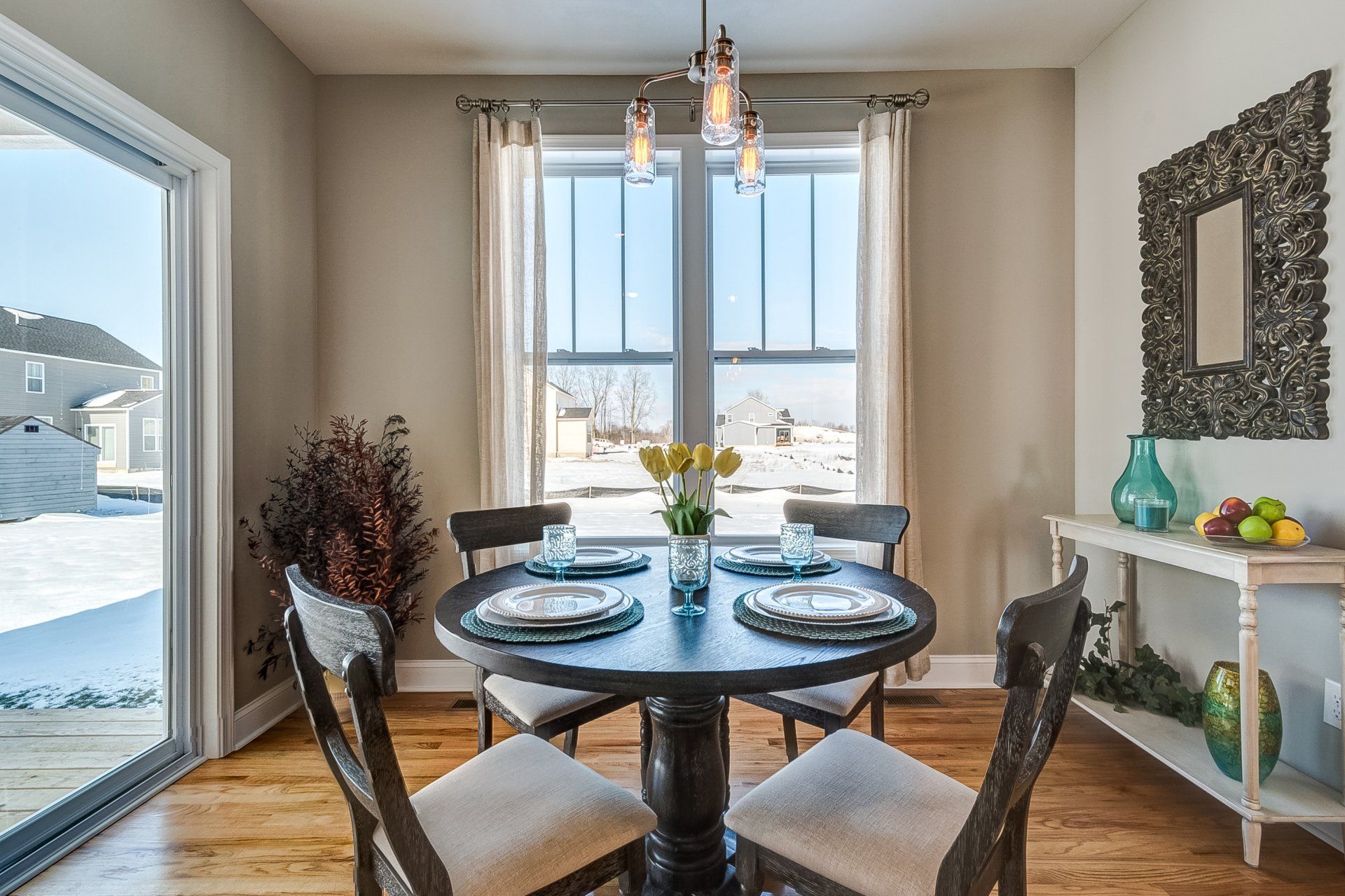 dinette with table set, console table, and door to deck