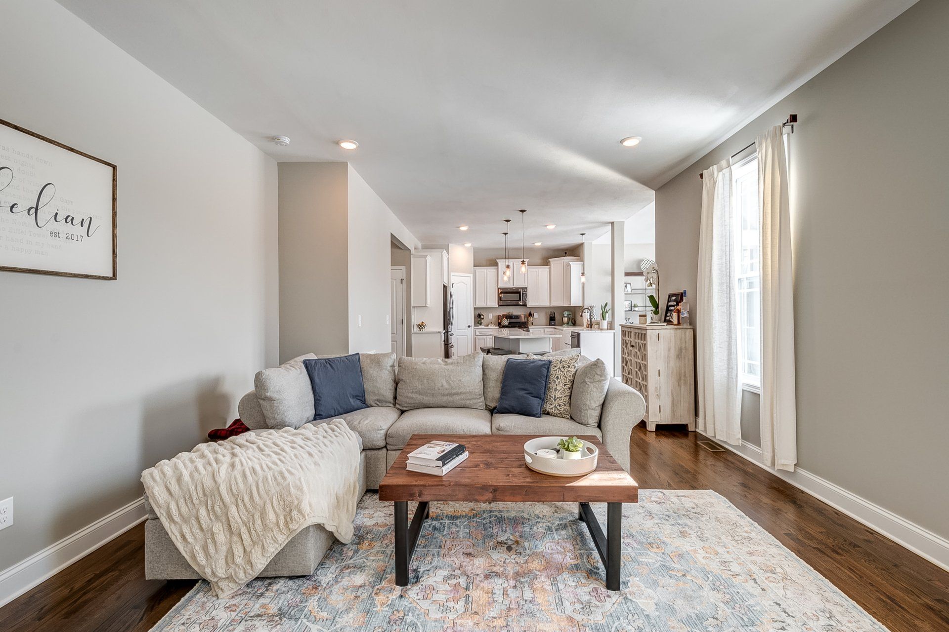 living room sectional and kitchen in background