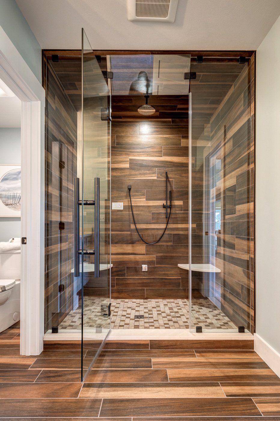 tile shower with built-in seats and water closet