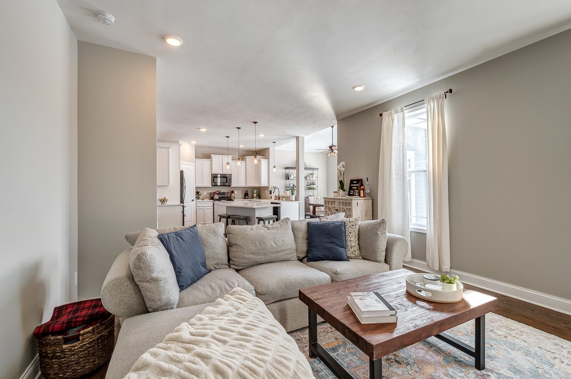 living room sectional and kitchen in background