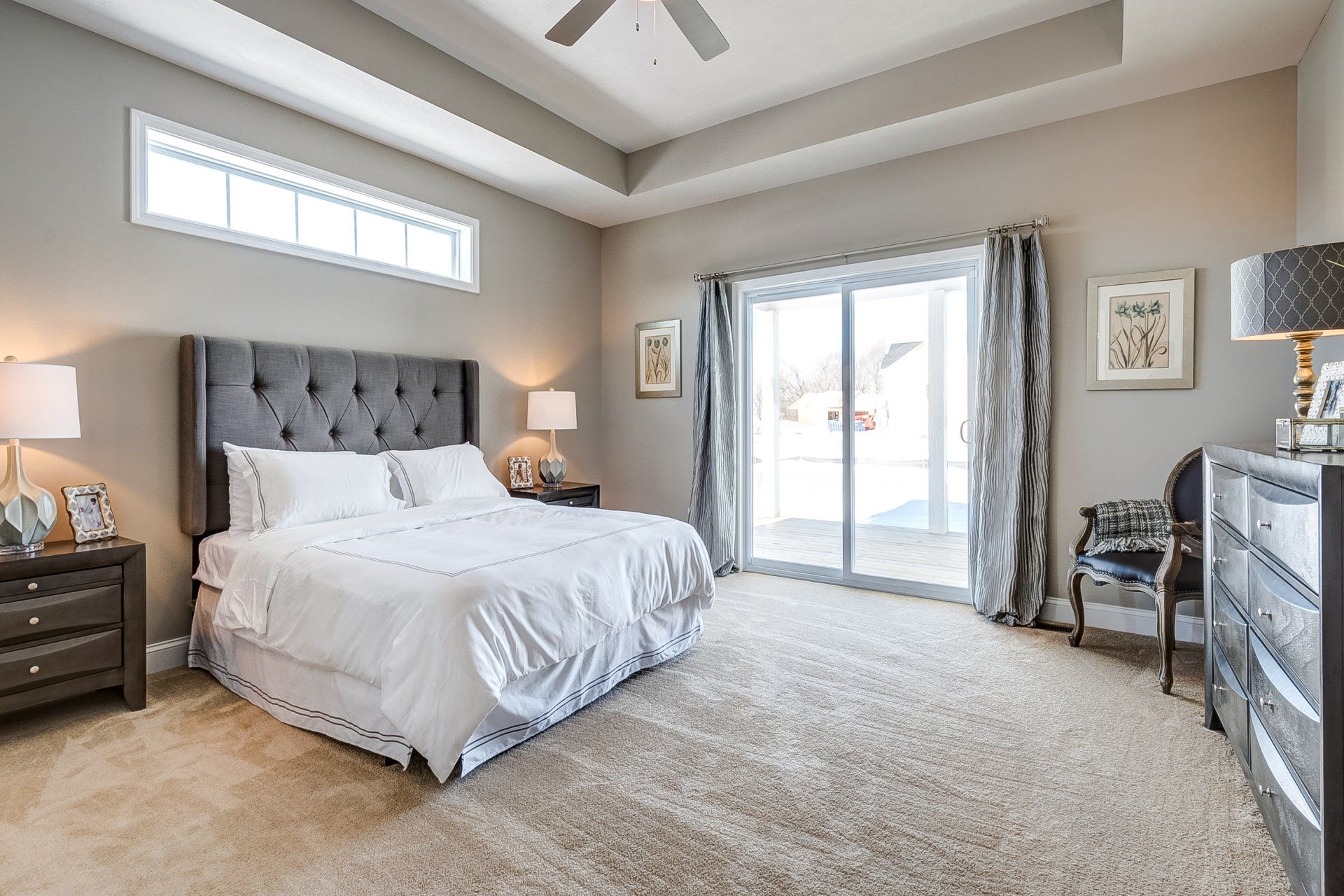 primary bedroom with recessed ceiling and deck access