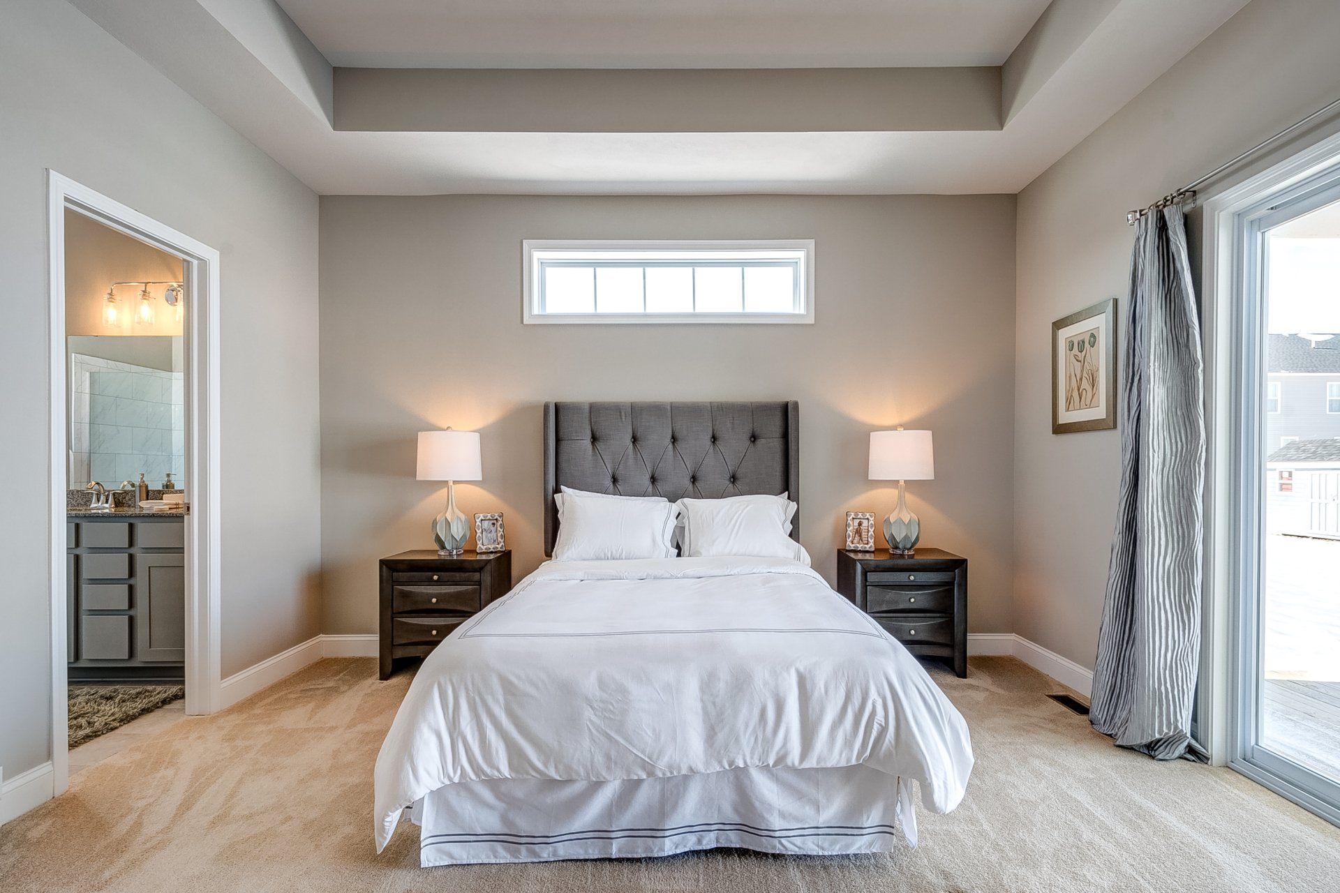 primary bedroom with recessed ceiling