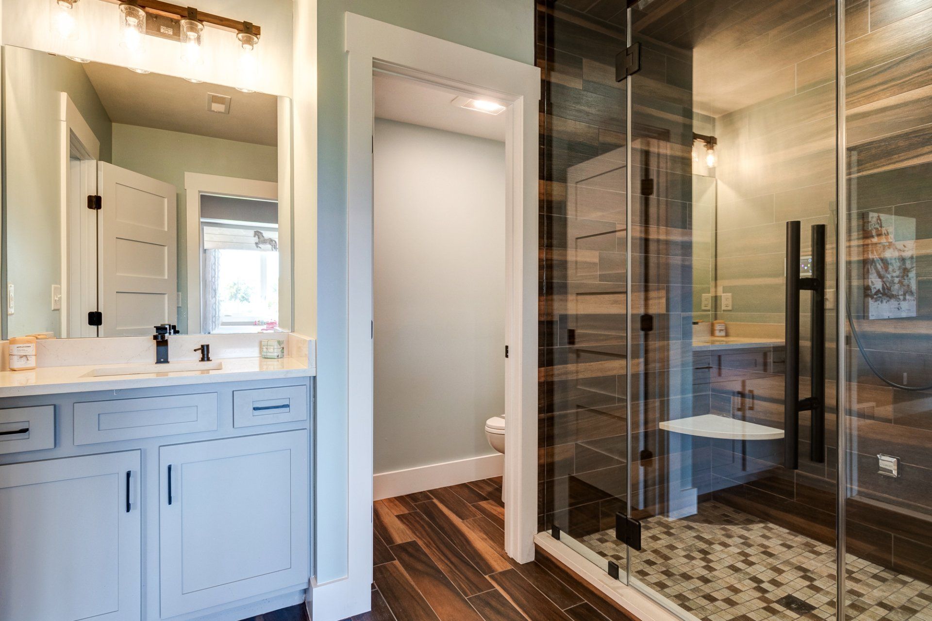 water closet and tile shower with built-in seat