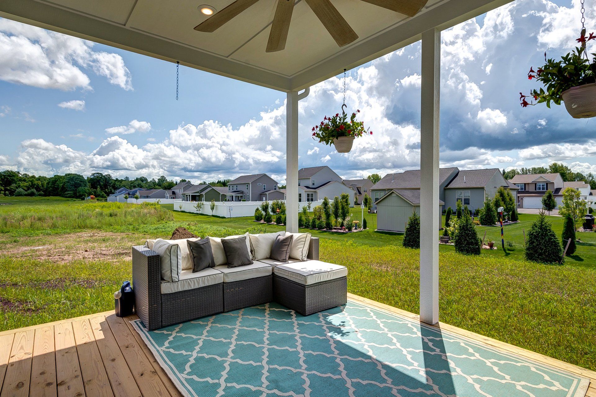 backyard and covered deck with ceiling fan and sectional