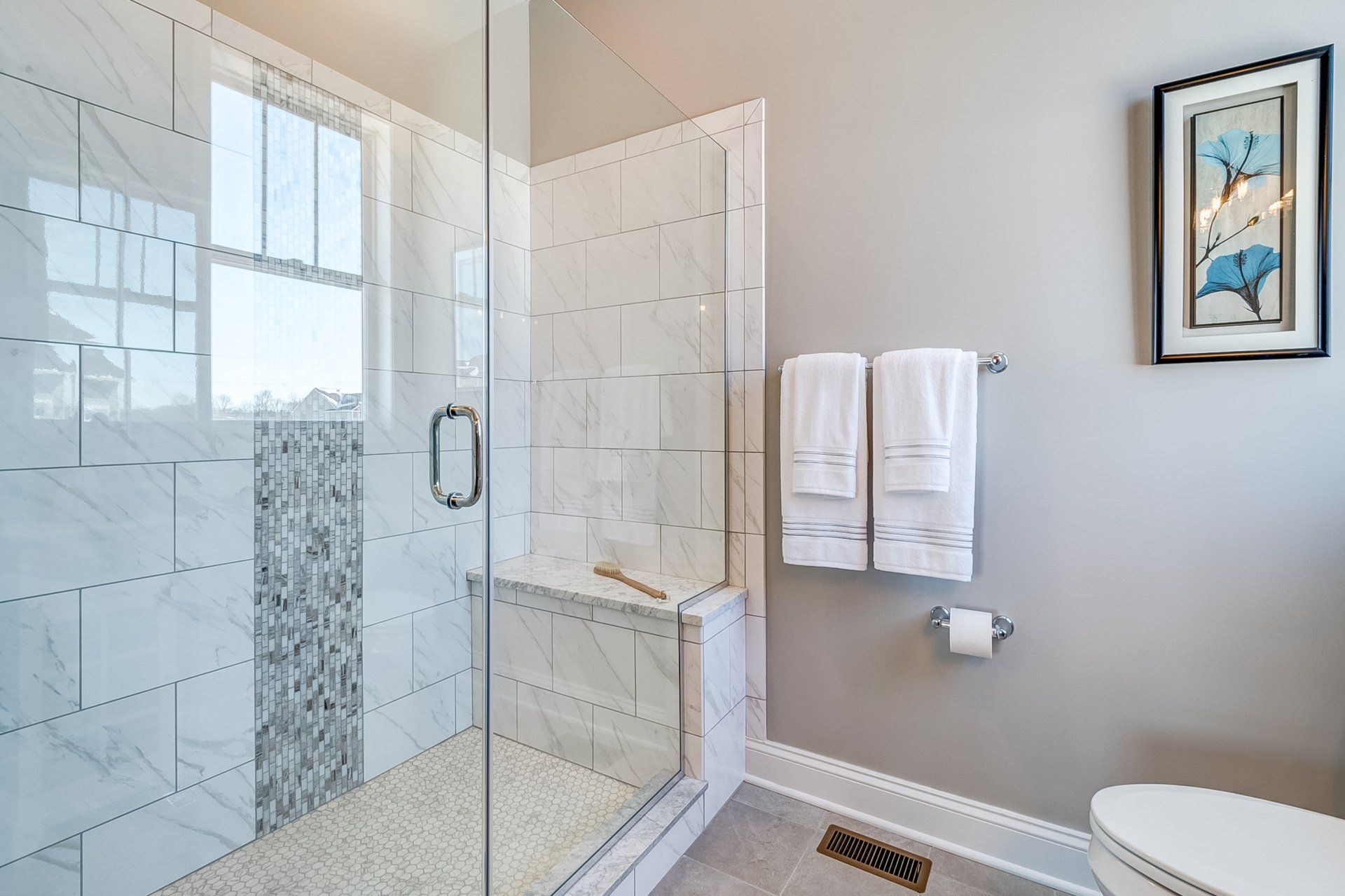 tile shower with built-in bench and glass door