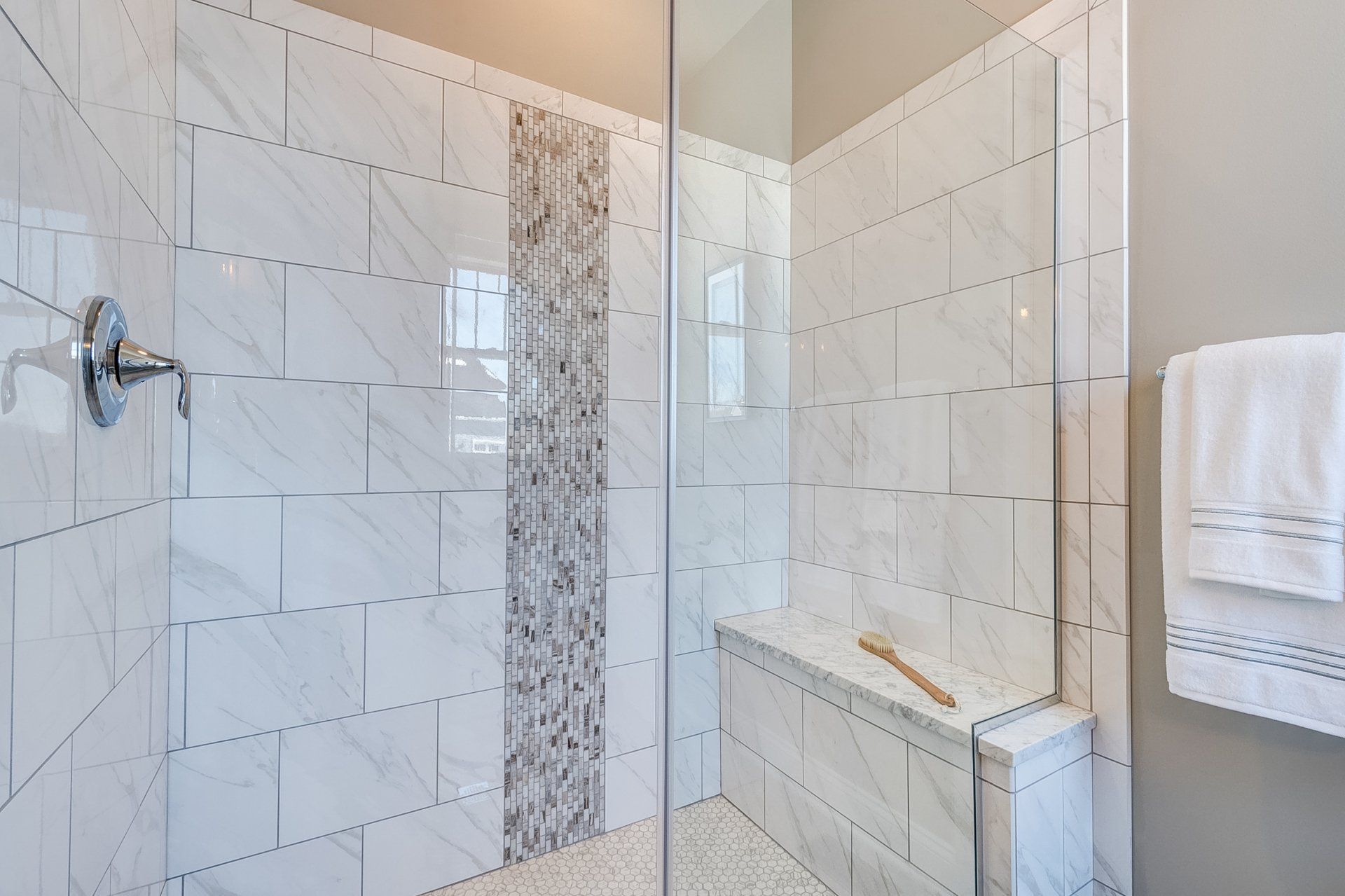 tile shower with built-in bench and glass door