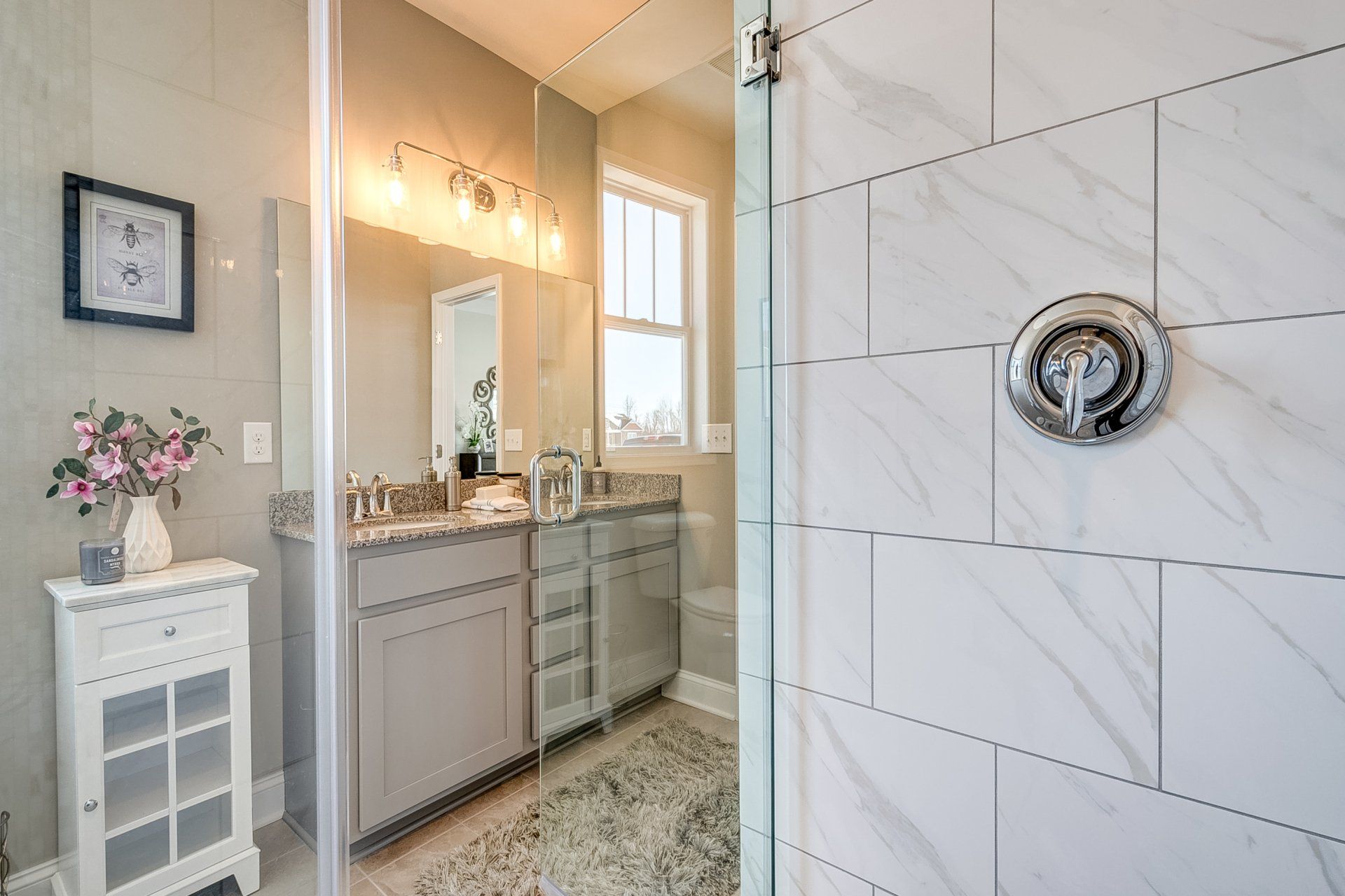 tile shower with glass door and double vanity