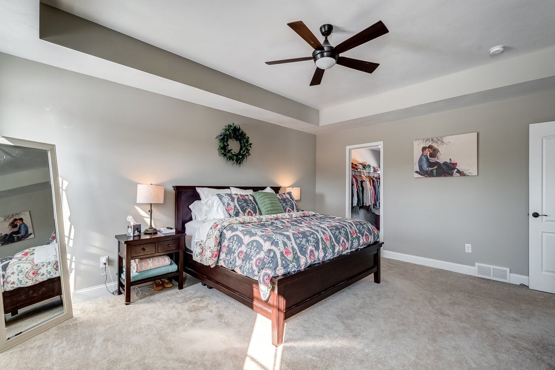 Primary Bedroom with Recessed Ceiling and Ceiling Fan