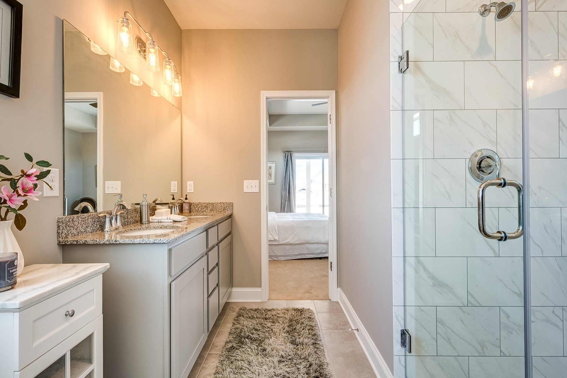 primary bathroom with double vanity and walk-in shower