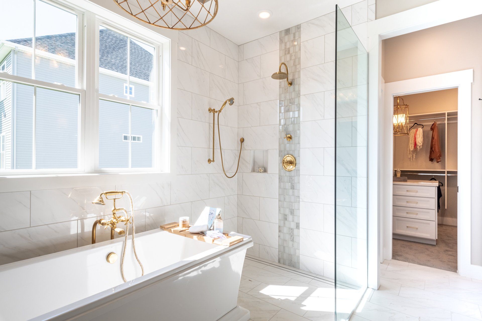 tub and shower with walk-in closet in background