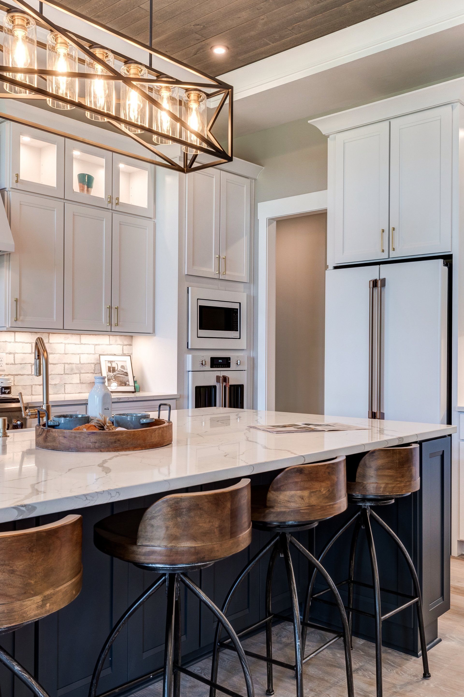 geometric light fixture over island with seating