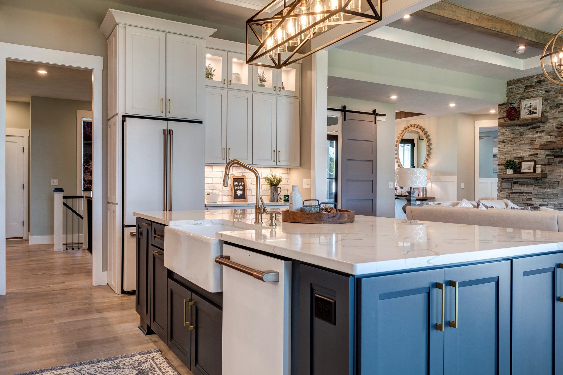 kitchen island with geometric light fixture above