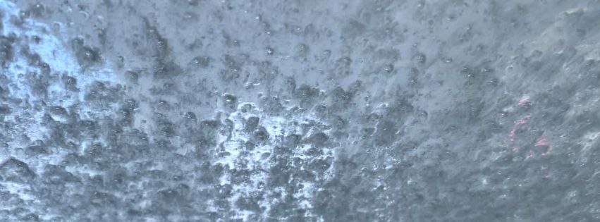 microscopic bubbles that form on a glass surface