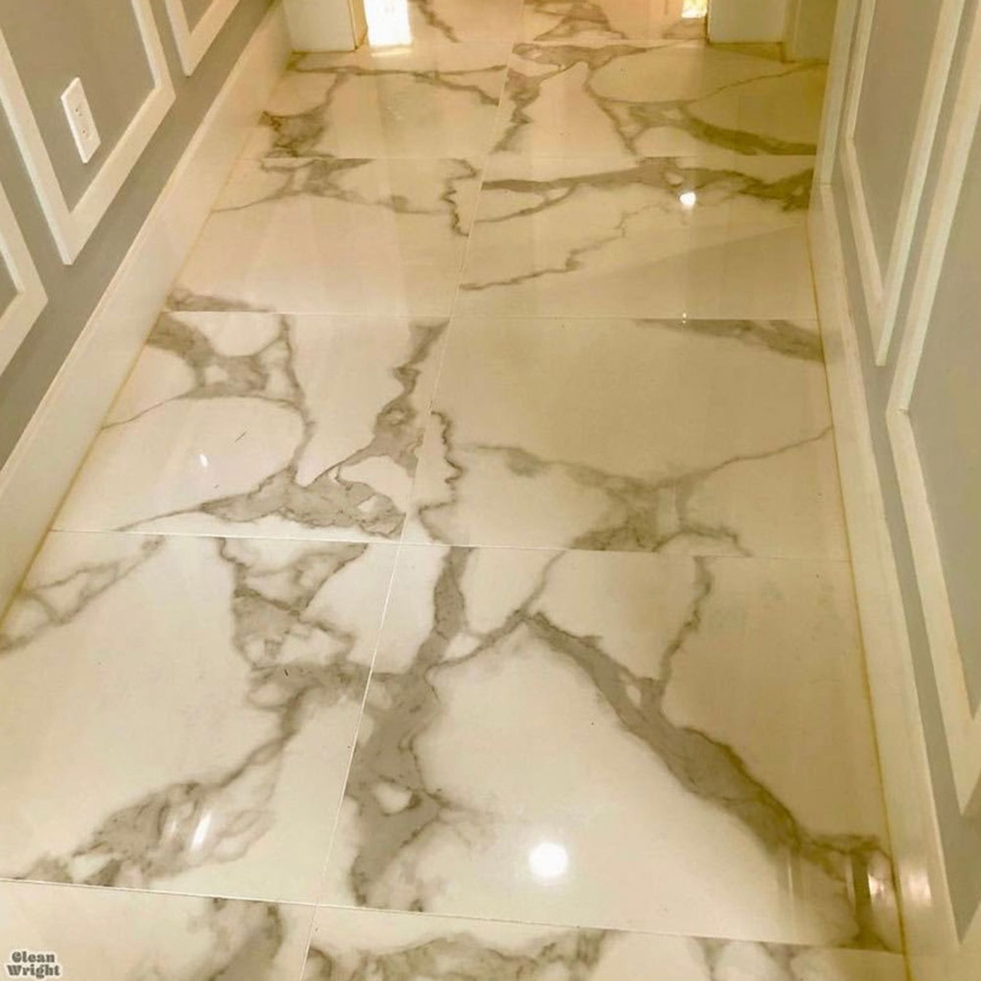 Polished marble hallway floor with cream and gold veining, viewed from above