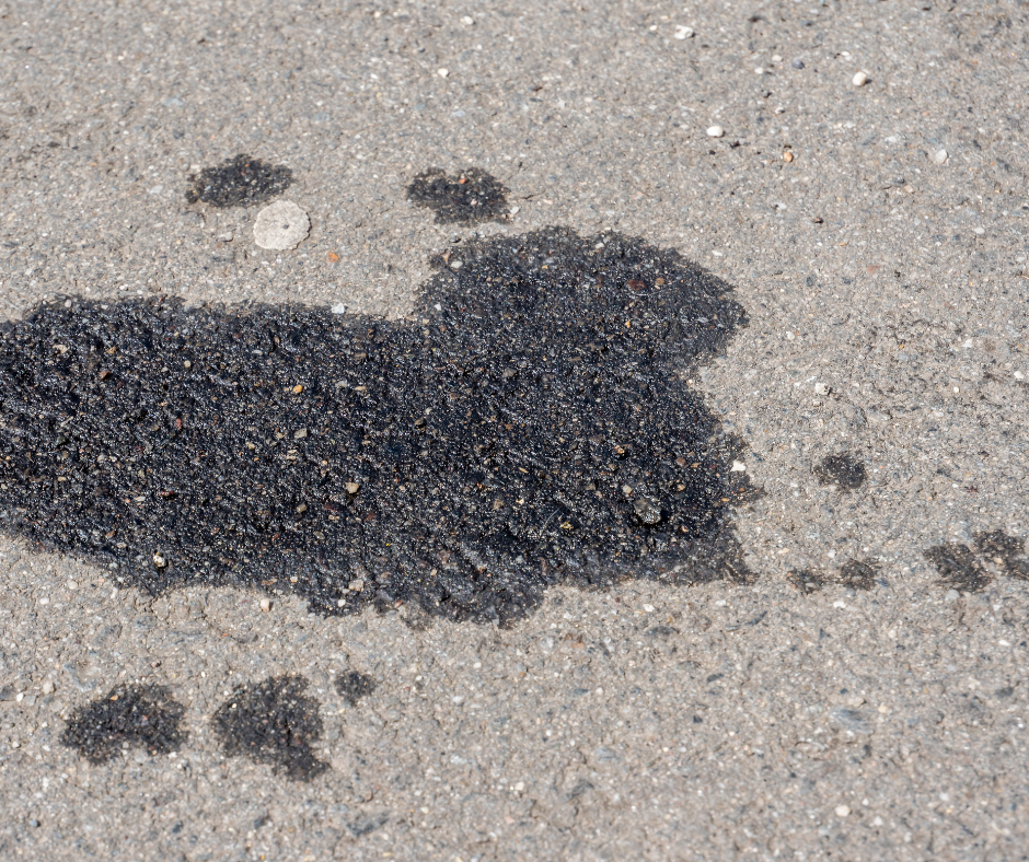 Dark oil stain on gray asphalt.