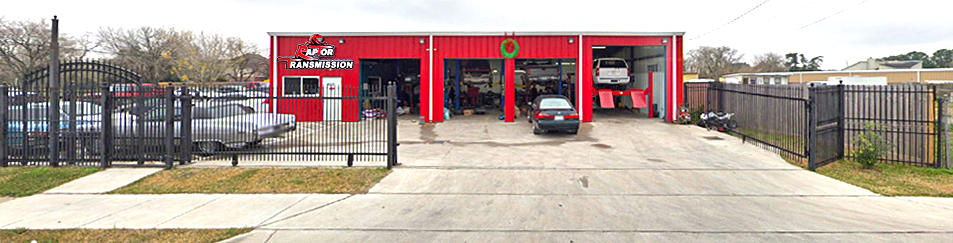 A car is parked in front of a tire shop.