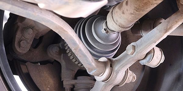 A close up of a drive shaft on a car.