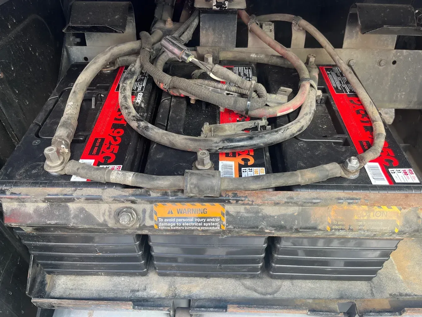 A bunch of batteries are sitting on top of each other in a car.