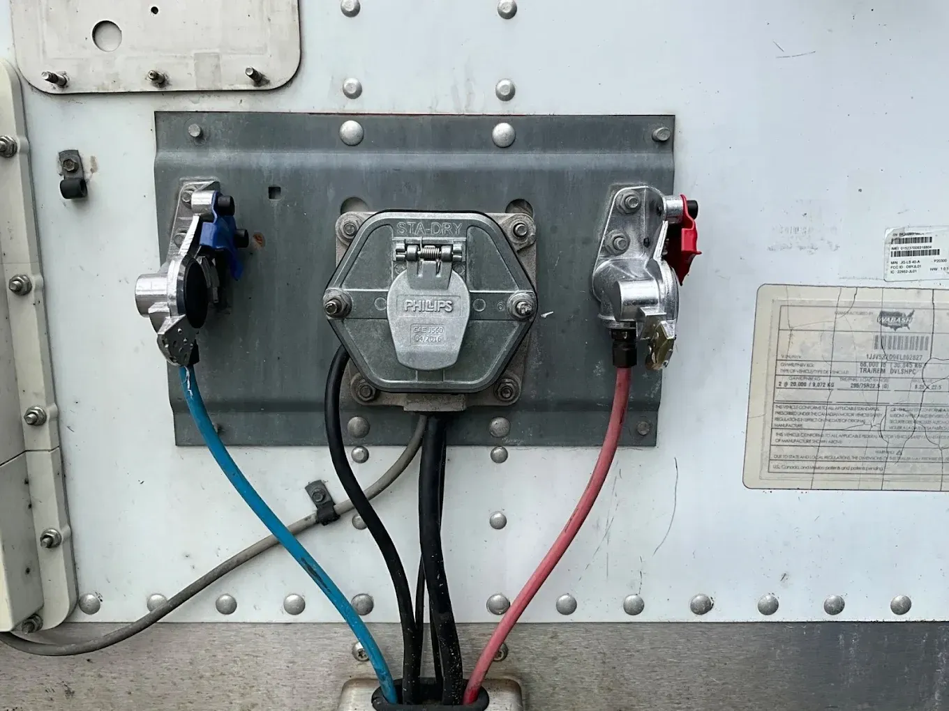 A close up of a electrical box with wires coming out of it