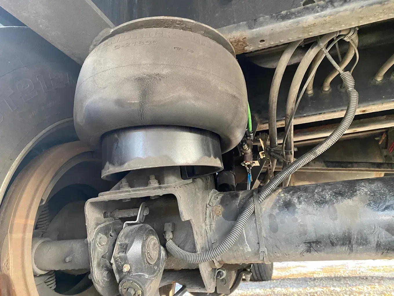 A close up of a suspension system on a truck.