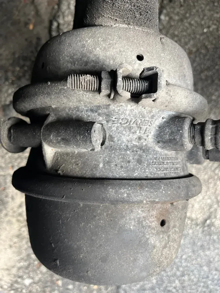 A close up of a metal object on a concrete surface.