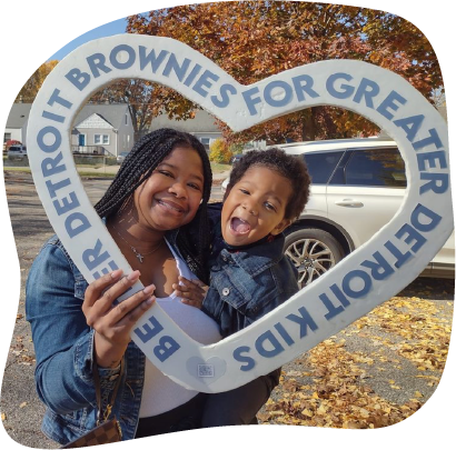 Woman and child holding heart-shaped sign: