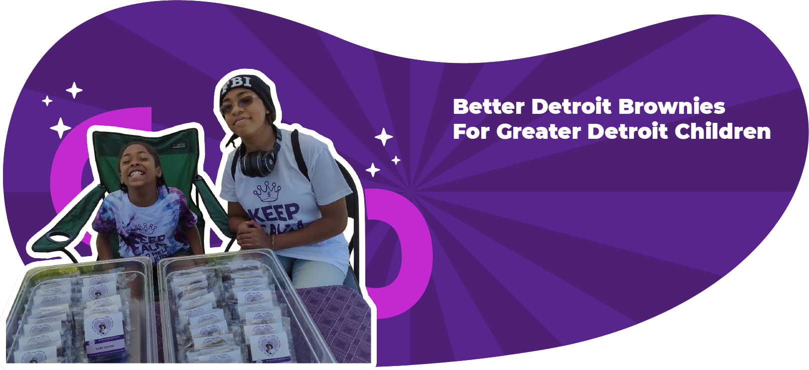 Two women selling brownies for charity in Detroit, in front of a purple backdrop.