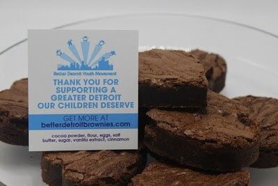 Brownies on a plate next to a card that says "Thank you for supporting a greater Detroit."