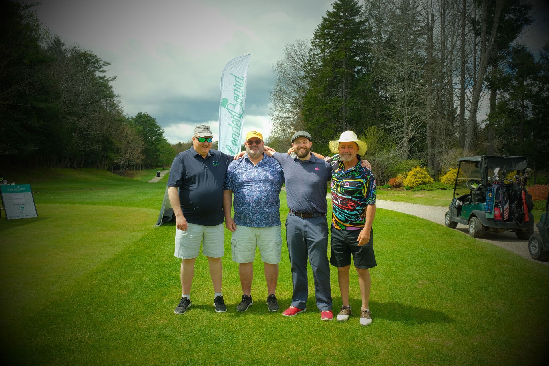 A group of men are posing for a picture on a golf course.