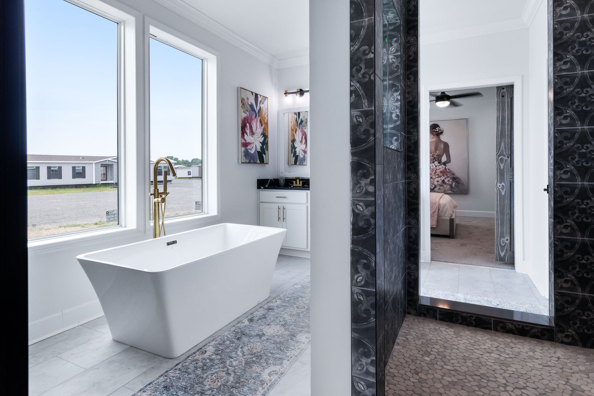 Modern bathroom with a white freestanding tub, large windows, and a walk-in shower with a full-length mirror