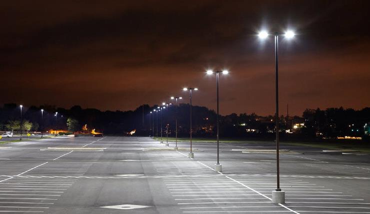 An empty parking lot is lit up at night